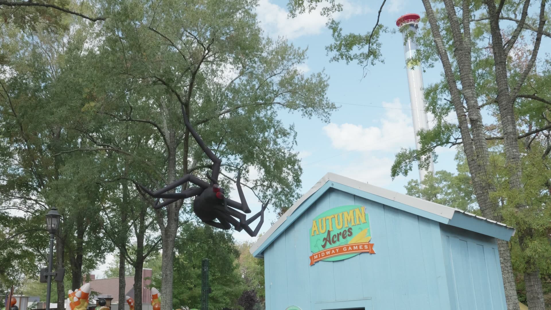 A large decorative spider above the Autumn Acres sign at Carowinds